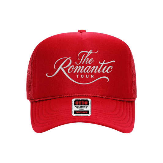 Front of a Unisex red trucker cap with "The Romantic Tour" embroidered on the front in white.